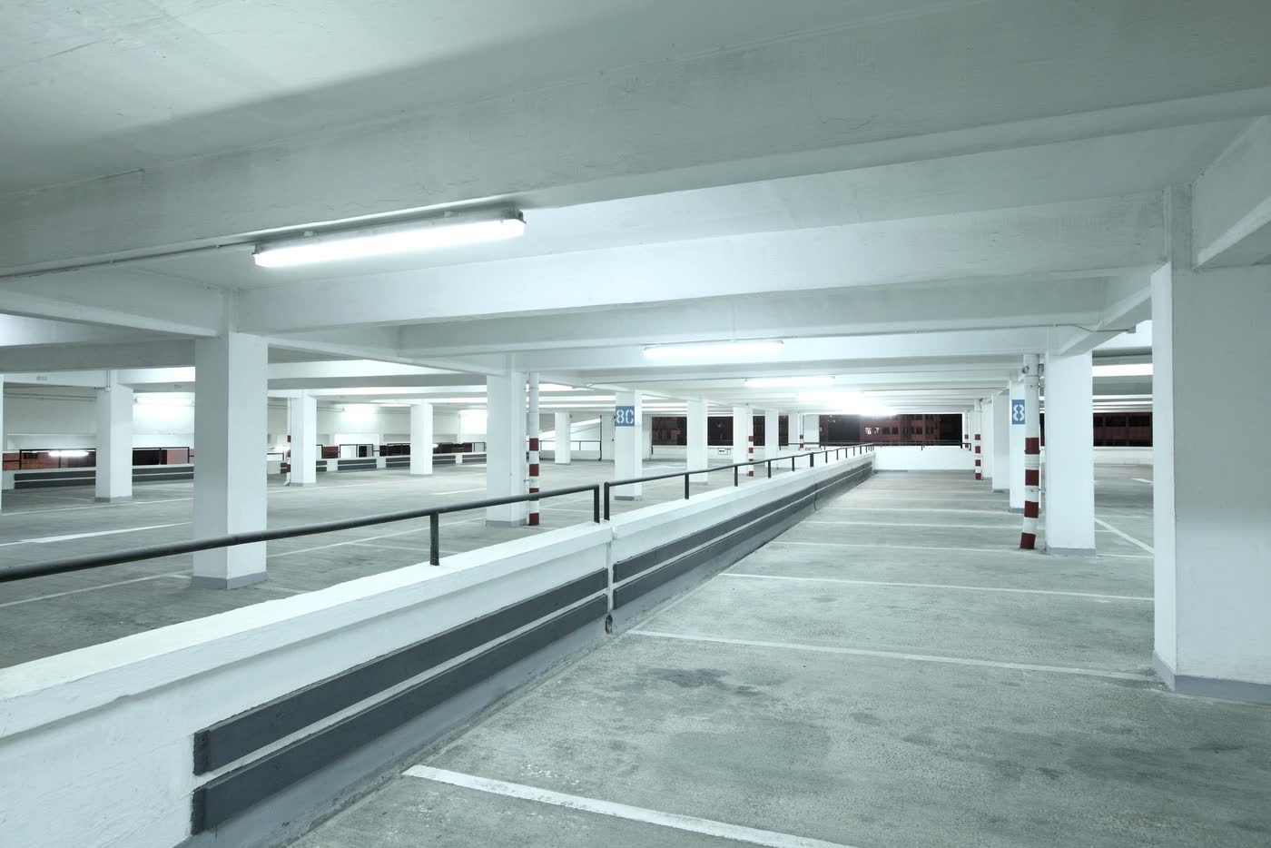 The drive lane of a parking garage, lit