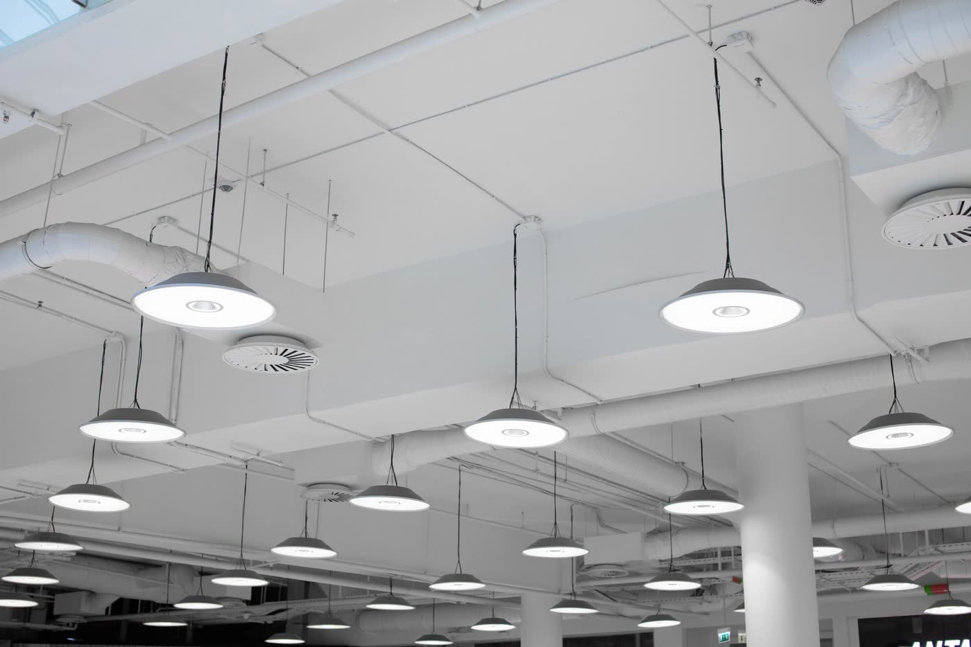 High-bay pendants over an open commercial floor