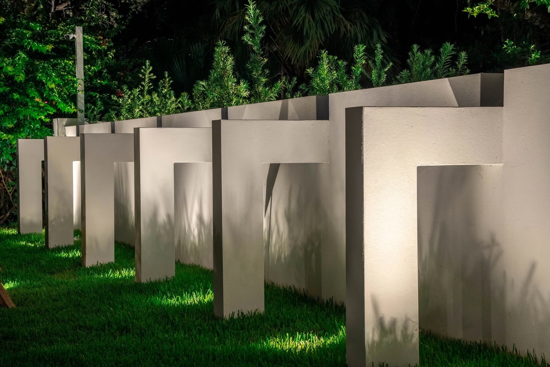 Sculptural garden walls lit at night